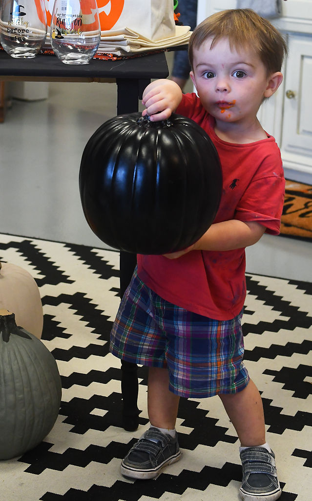 Beckham Czerney, 2, holds up a pumpkin on Thursday